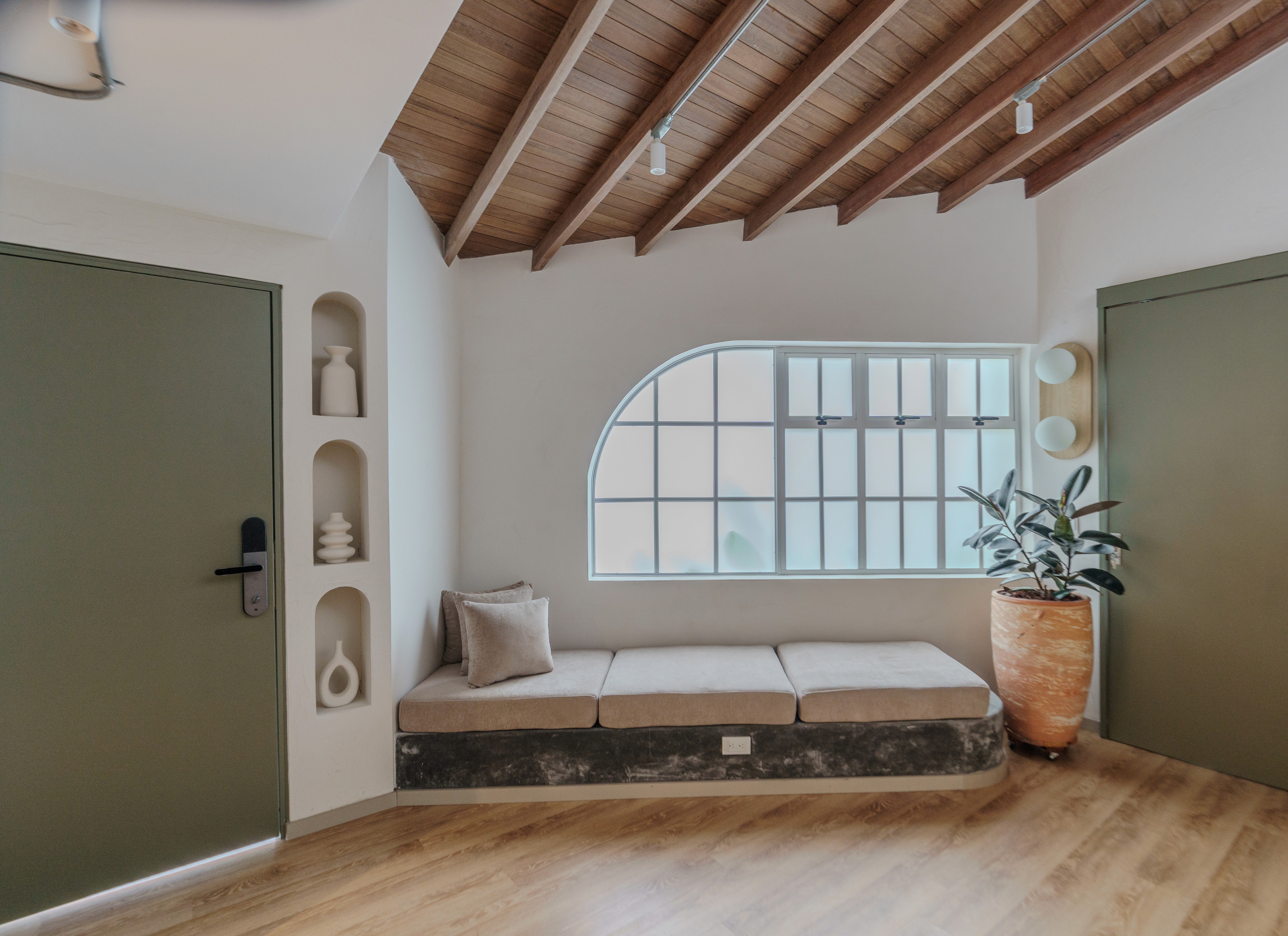 Double-height interior with flowing sculptural forms and warm raking light