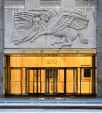 Exterior of a building with orange awnings and a sign above the door that reads “Prospect.”