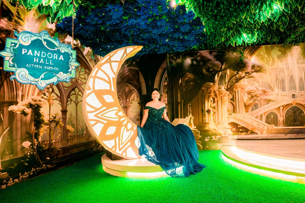 Debutante in navy seated on the crescent moon at Pandora Hall, Stalla Suites QC