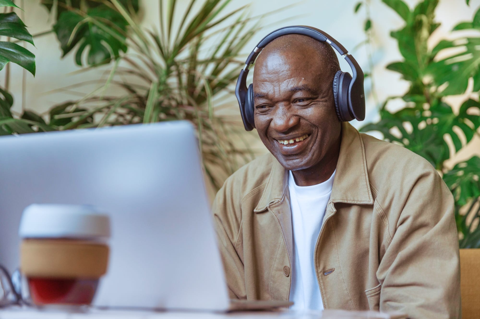 man using a computer with headphones