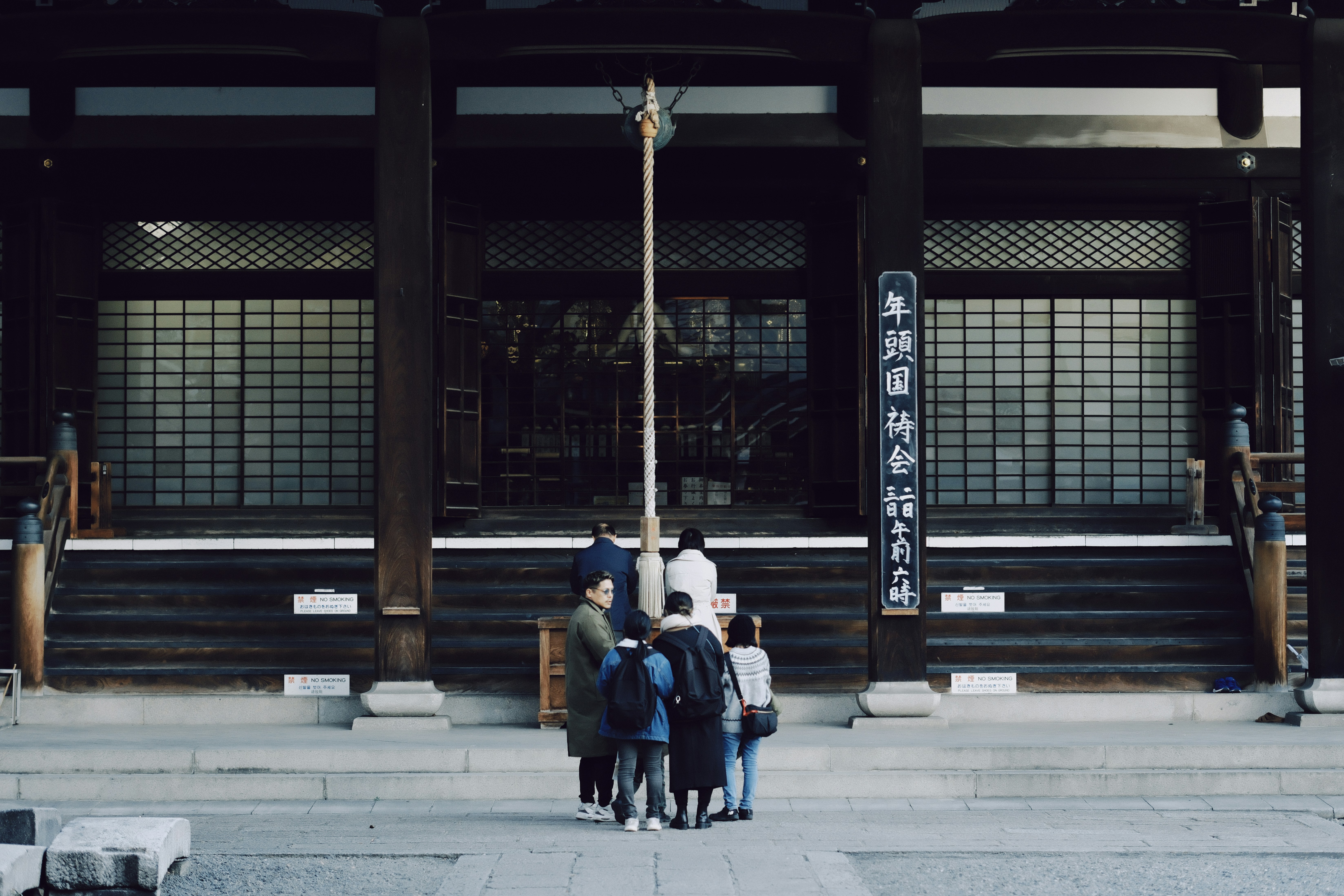 Group of people gathered in front of shrine in Japan