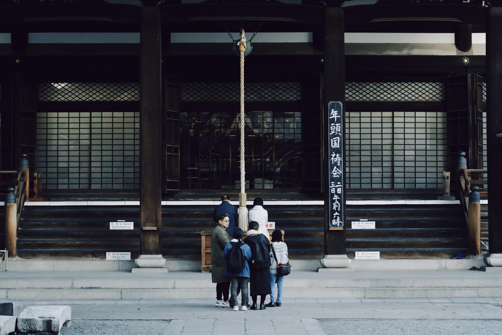 Group of people gathered in front of shrine in Japan