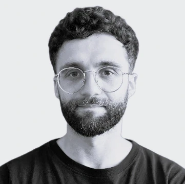 Black and white profile picture of Ardit Naka who is the Co-Founder - Content at KanataQ