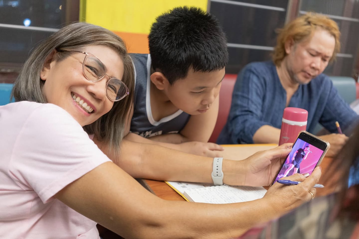 two young boys brushing their teeth in front of a crowd