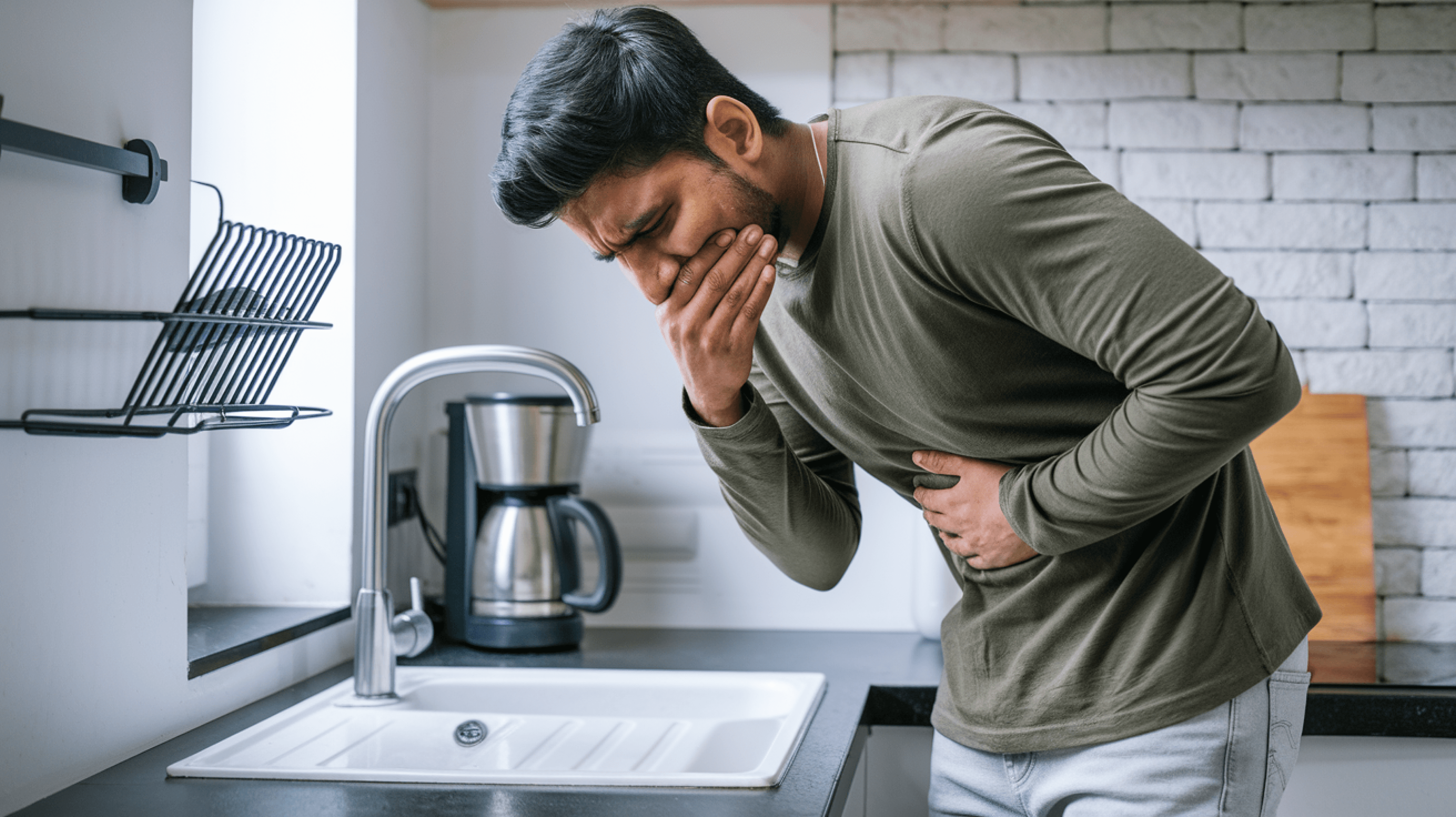 Man experiencing nausea, a common side effect of GLP-1 medication