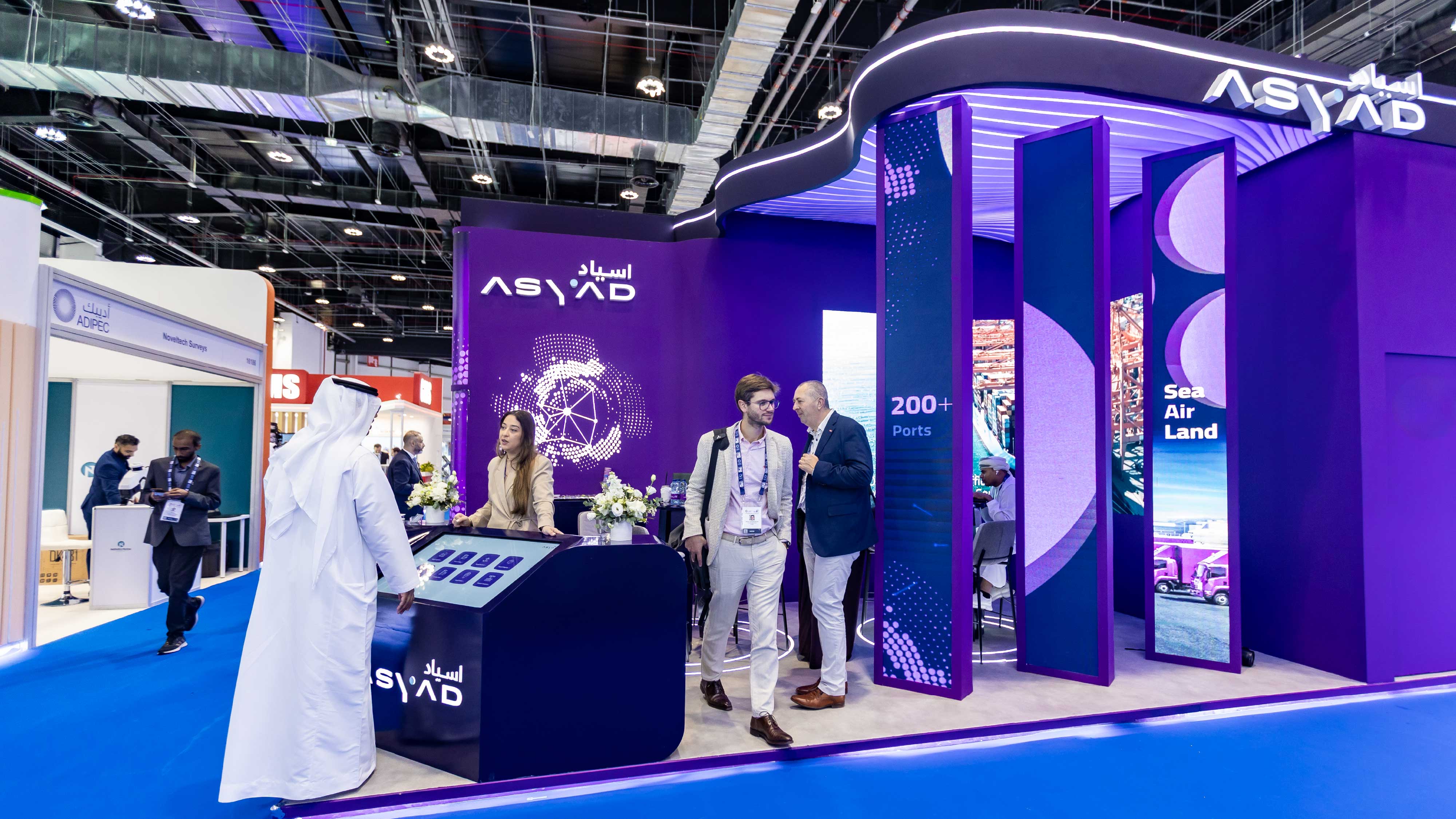 Building with red banner and lush green tree