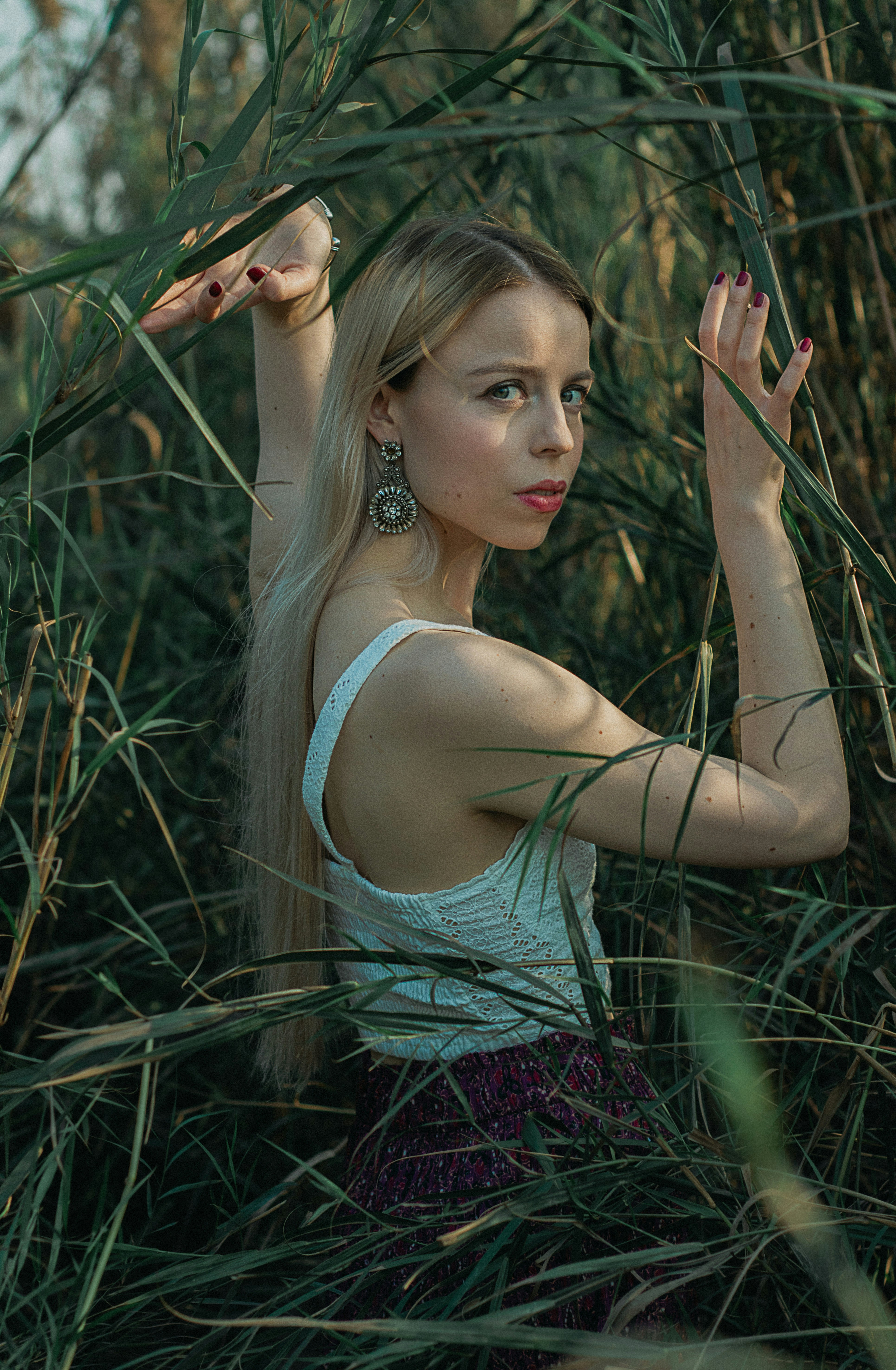 a woman standing in a field of tall grass