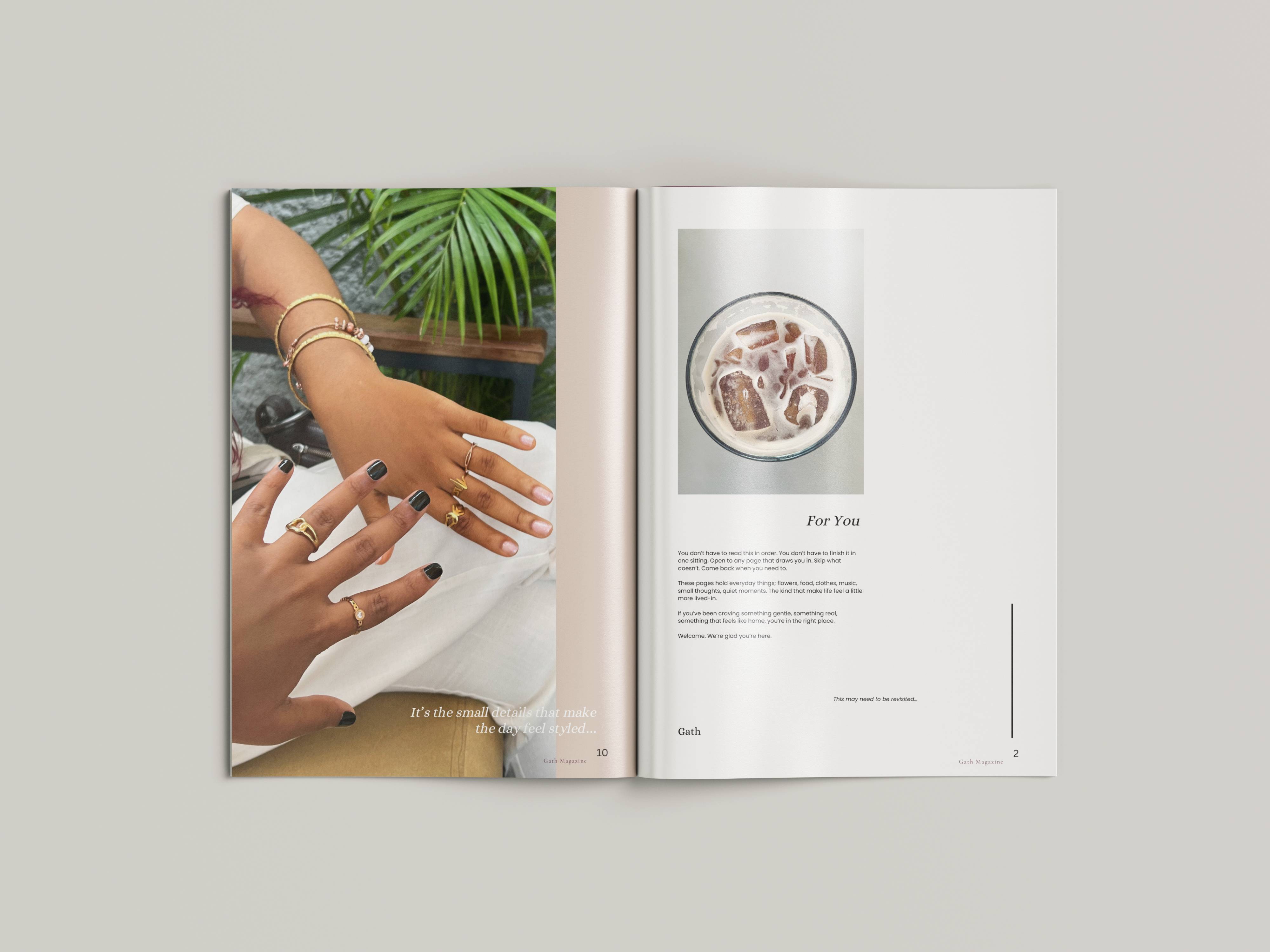 White plate with roasted carrots served on green sauce, topped with almonds and fresh herbs, held by a hand over a dark table.