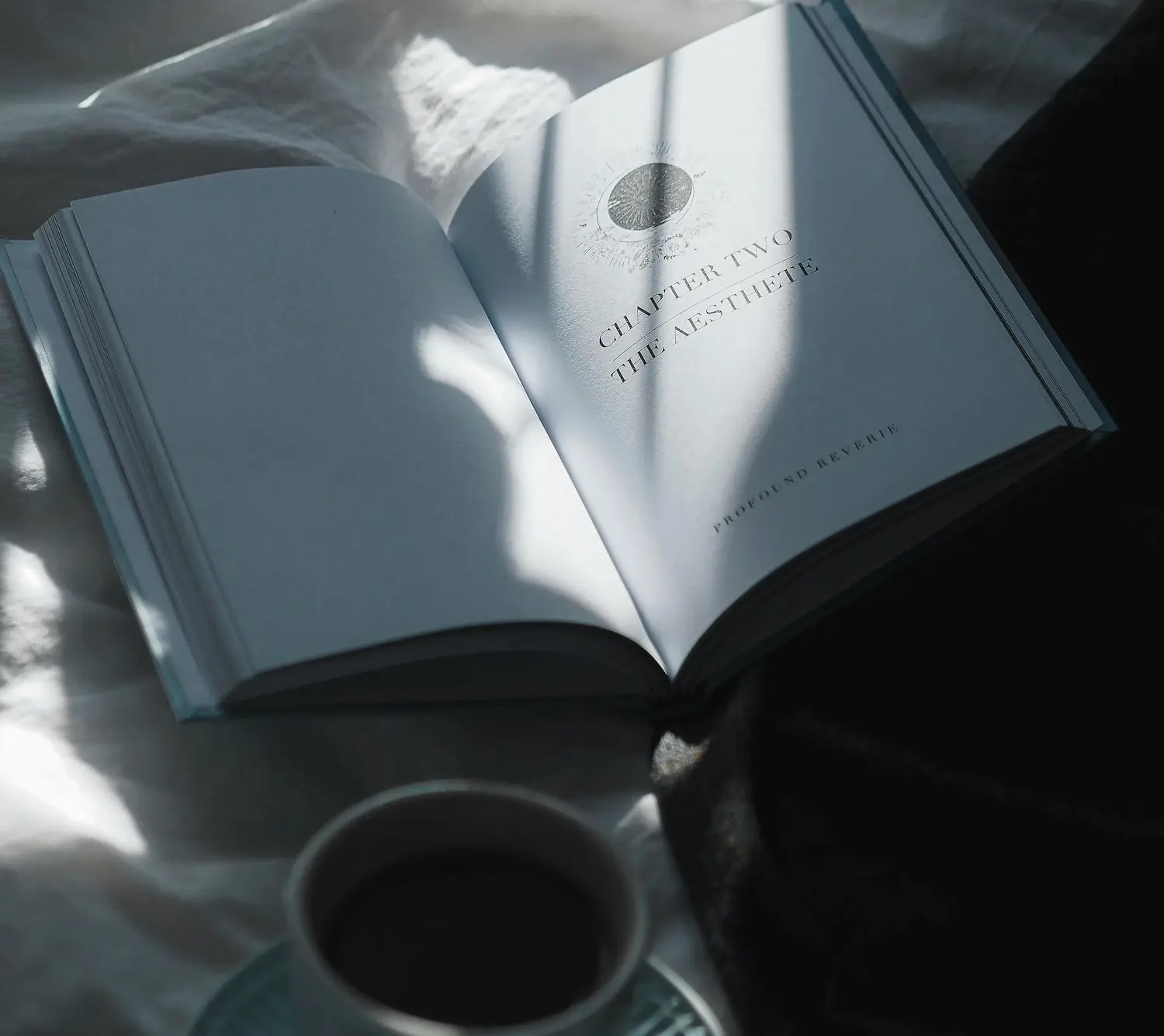 Open book resting on soft white bedding with morning sunlight streaming through a window, symbolizing reflection, personal growth, and emotional healing.