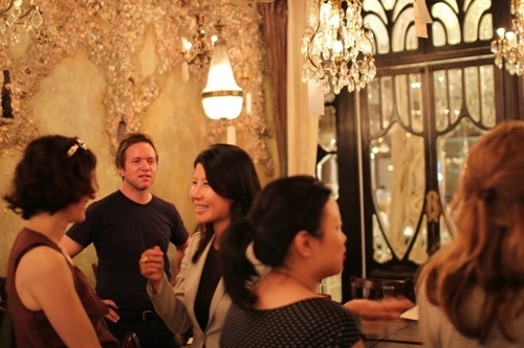 image of a group of people in a restaurant talking to each other