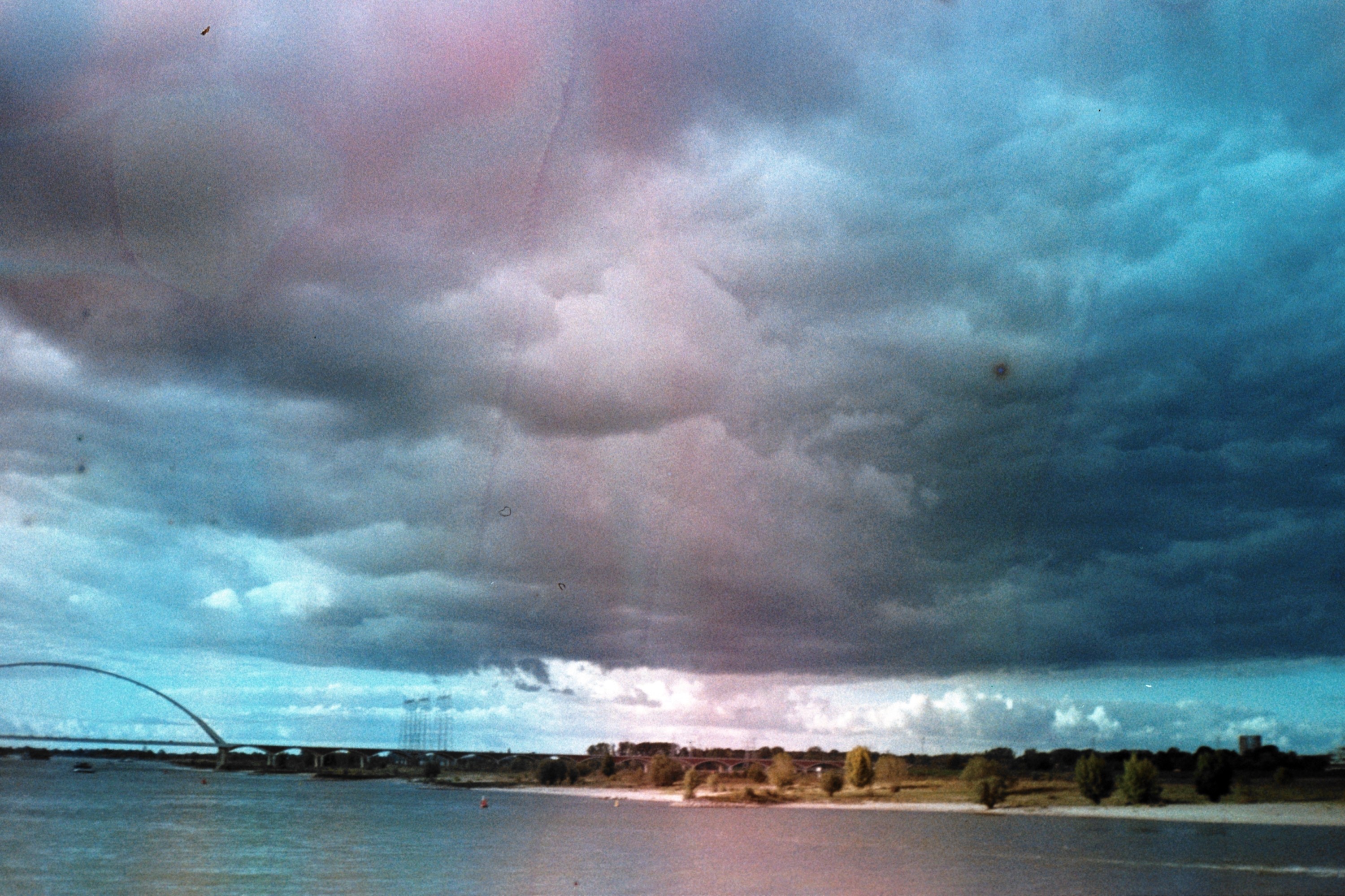 Creative portrait with geometric pink eyewear and bold fashion styling in urban setting