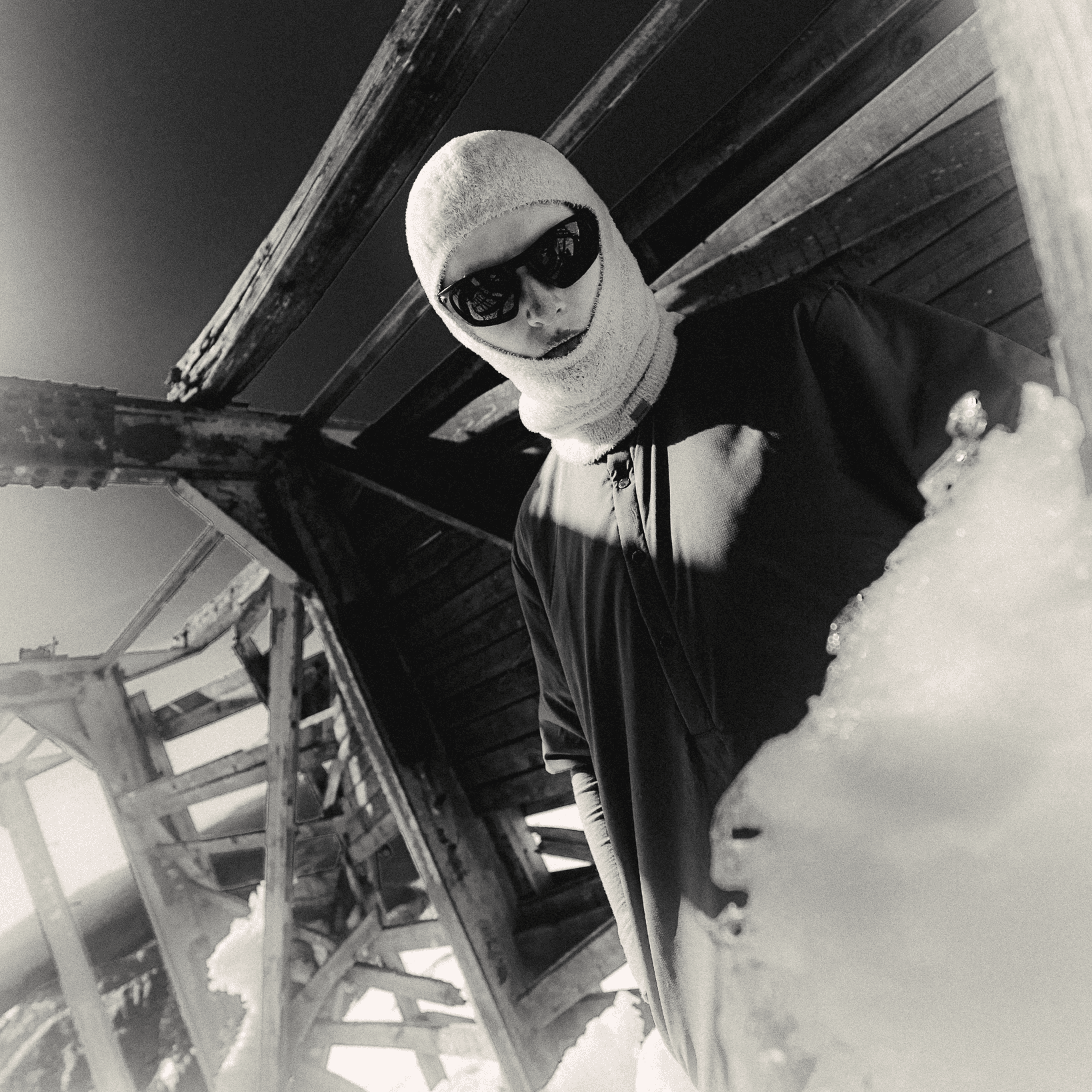 portrait of a woman wearing a balaclava and sport sunglasses.
