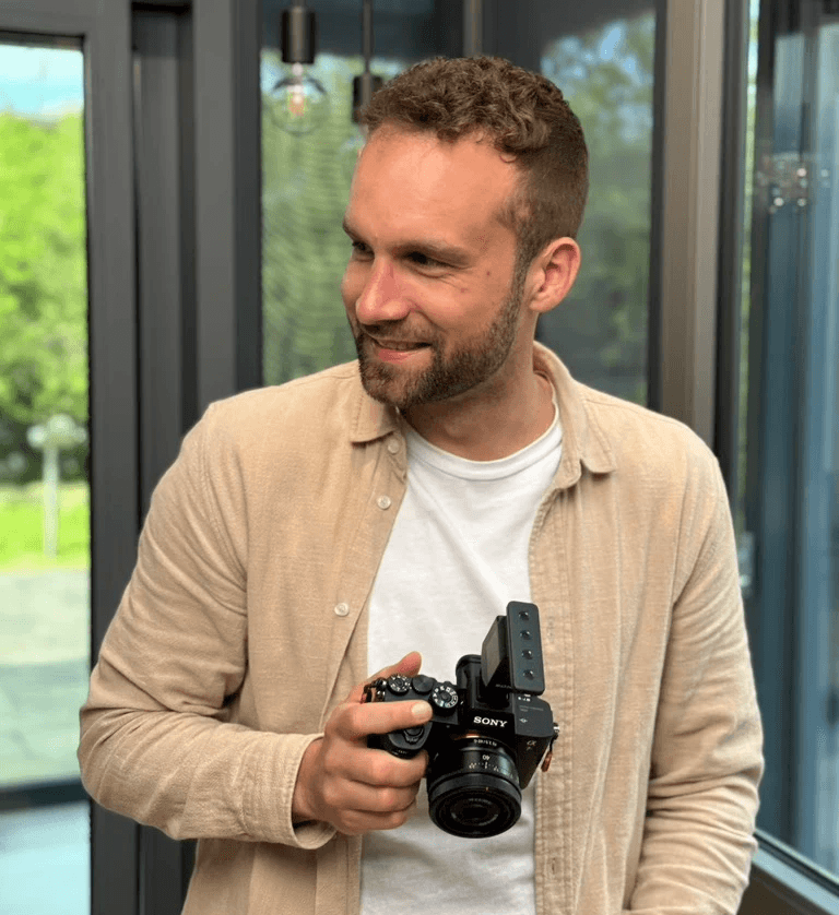 Woman with large sunglasses and jewelry touching her face