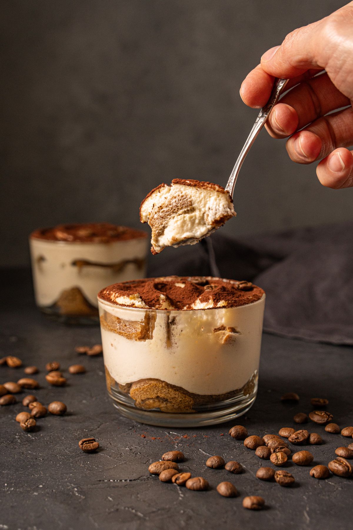 Tiramisu Cup from PASTA 9 Toronto, espresso-soaked sponge layered with mascarpone cream and cocoa for an indulgent Italian dessert.