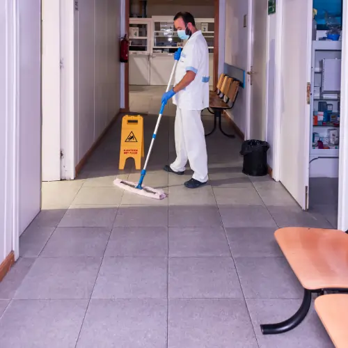 professional medical office cleaning service disinfecting a patient waiting area