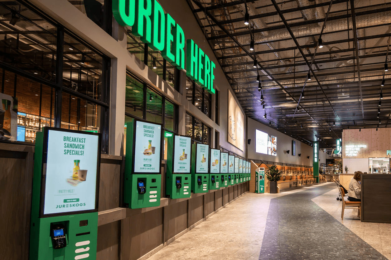 Self-order kiosks with 'Breakfast Sandwich Specials' display