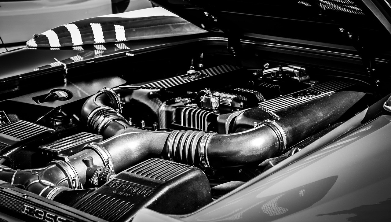 Modern bathroom featuring a walk-in shower, wooden vanity, round mirror, and elegant marble tiles.