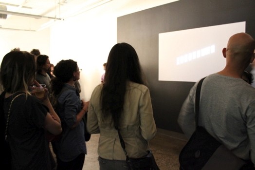 people looking at a presentation projected on the wall