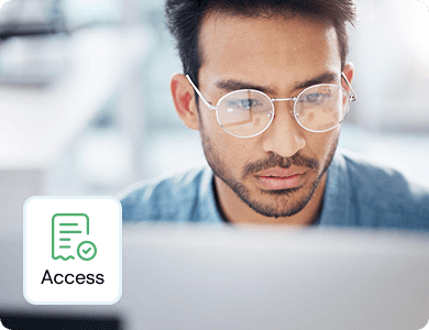 Man working on a laptop with a floating “Access” icon, representing organised digital invoice management.