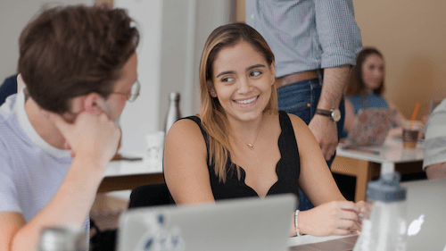Smiling young women and man in a conversation.