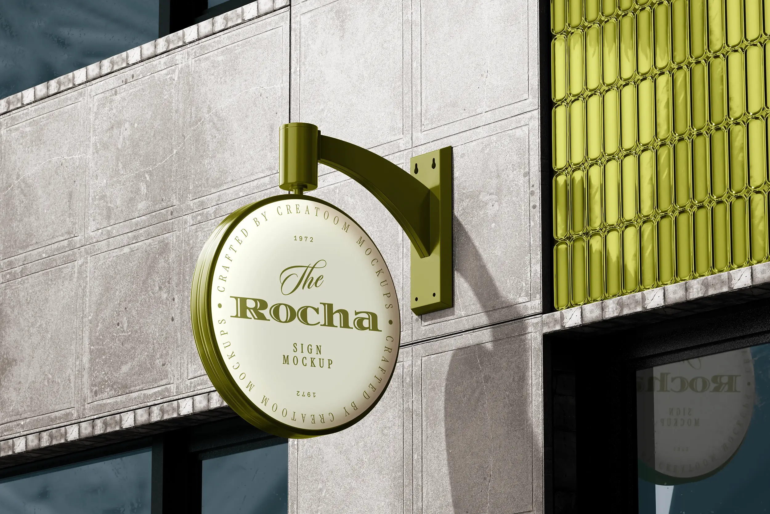 Round cream shop sign with an olive bracket on a stone café wall