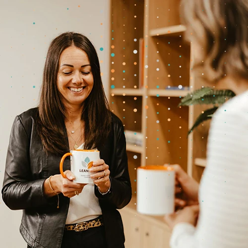 Lean Tree consultants holding mugs having a meeting