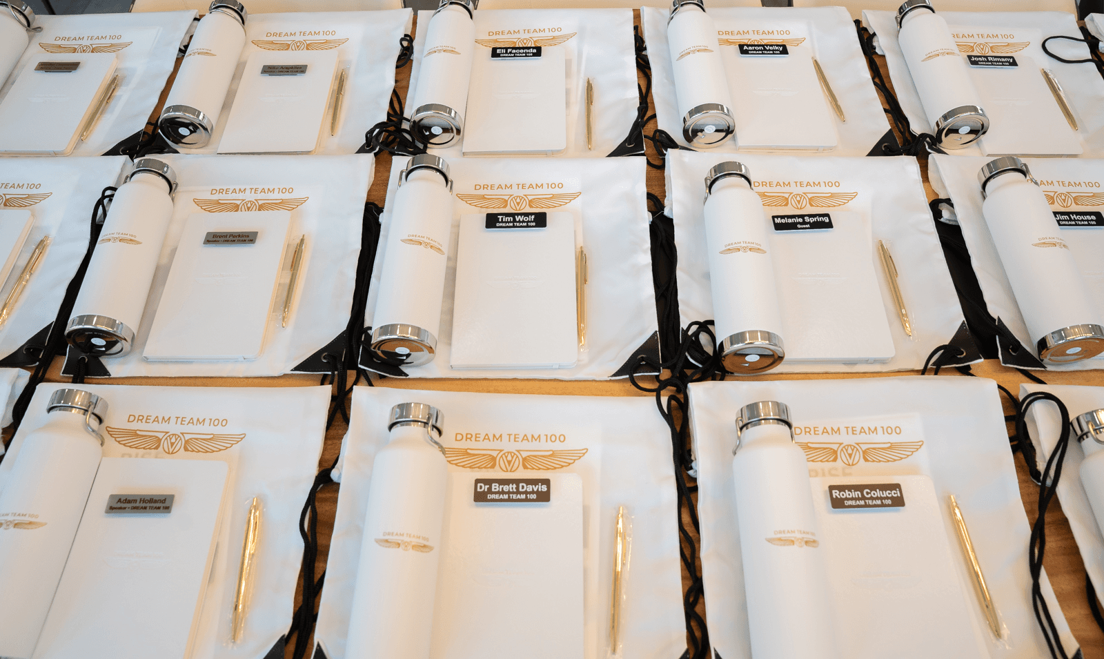 Three people sitting on a couch in a room looking at mobile devices