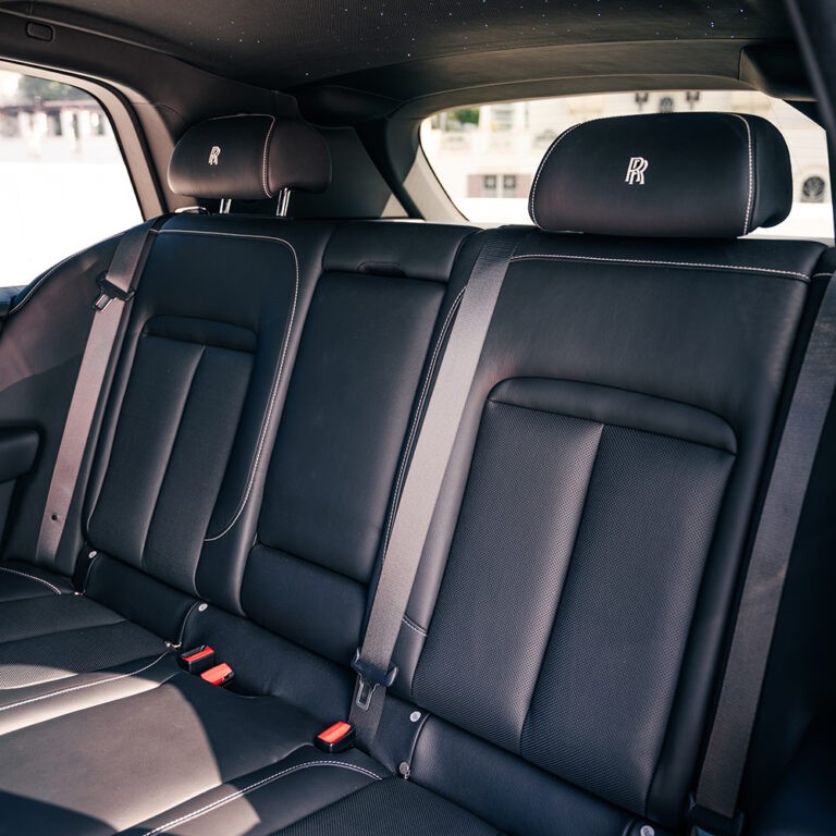 Luxurious rear interior seating of the Rolls-Royce Cullinan, emphasizing comfort and premium materials.