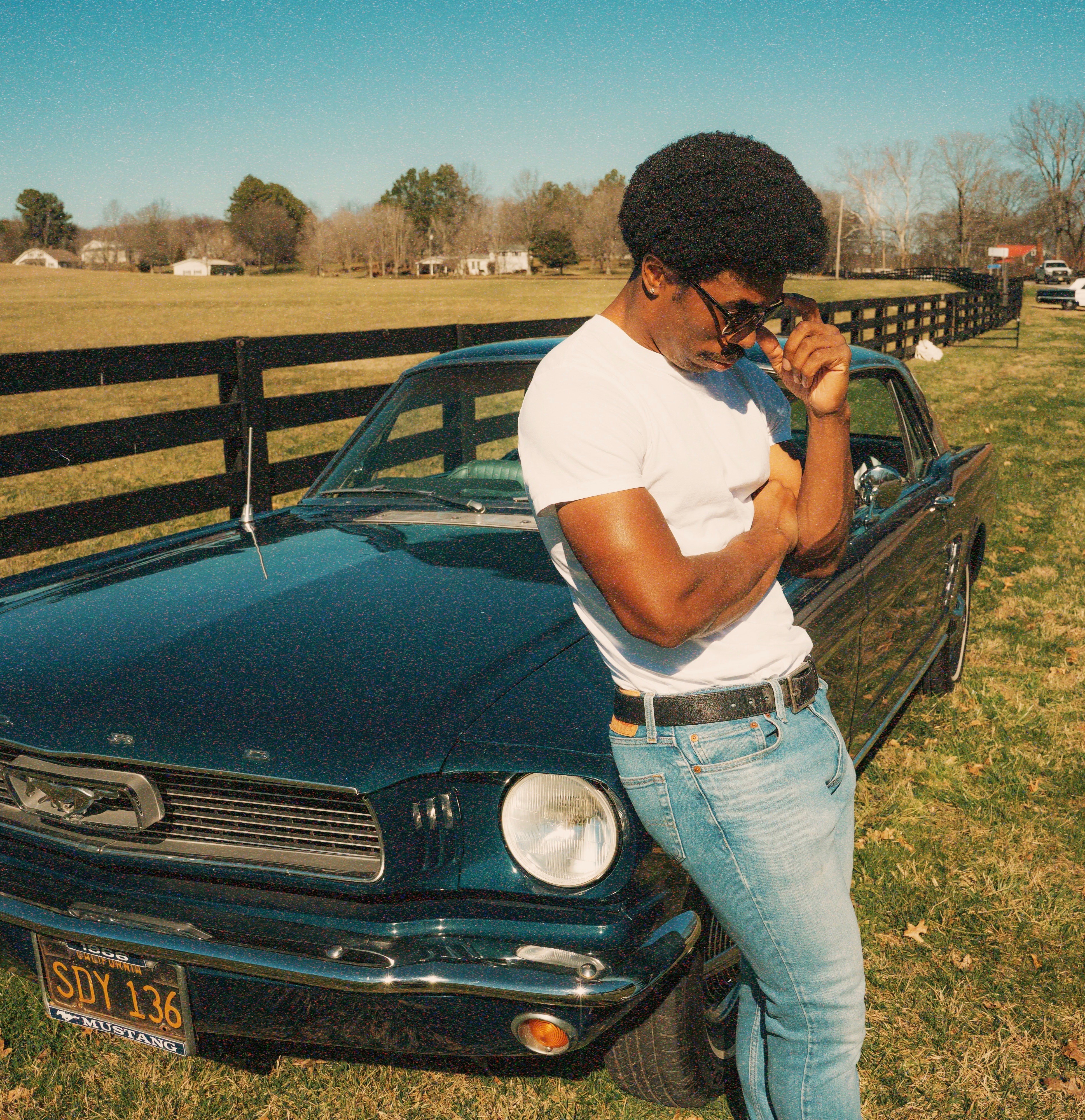 Nathan standing in front of a car