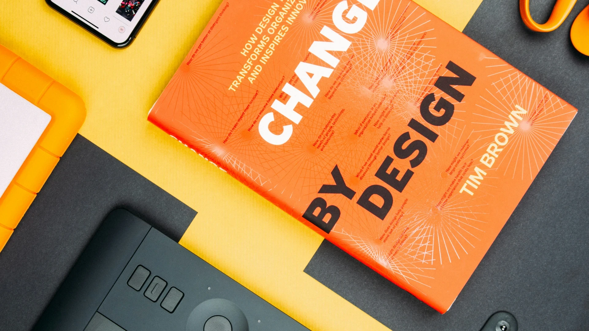 Change by Design by Tim Brown book beside smartphone