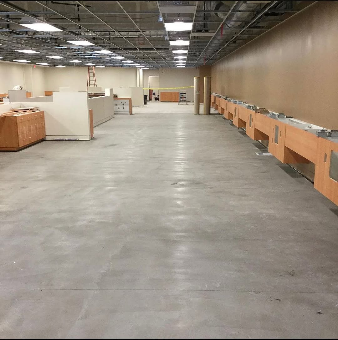Bare concrete slab running the length of a clinic floor before installation