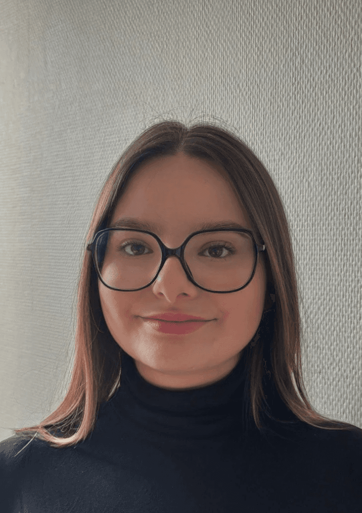 A woman sitting in a chair with her hand on her head