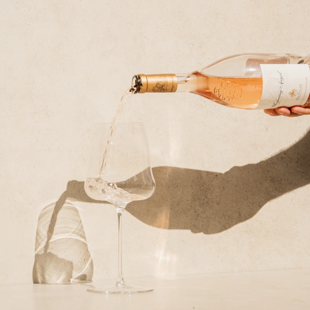 A close-up of a person wearing green-tinted glasses, with a serious expression and smooth skin.