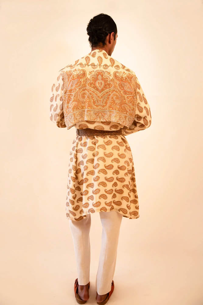 Vedya is our one-of-a-kind beige paisley silk trench coat, handcrafted by skilled artisans in-house using a vintage silk sari.