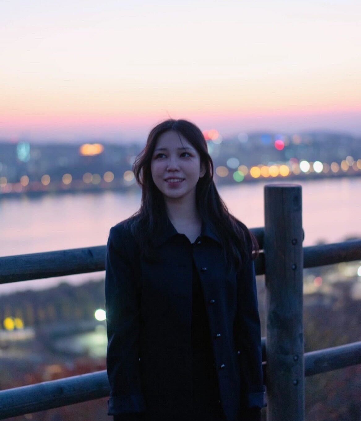 Portrait of a person in dark clothing speaking on a phone