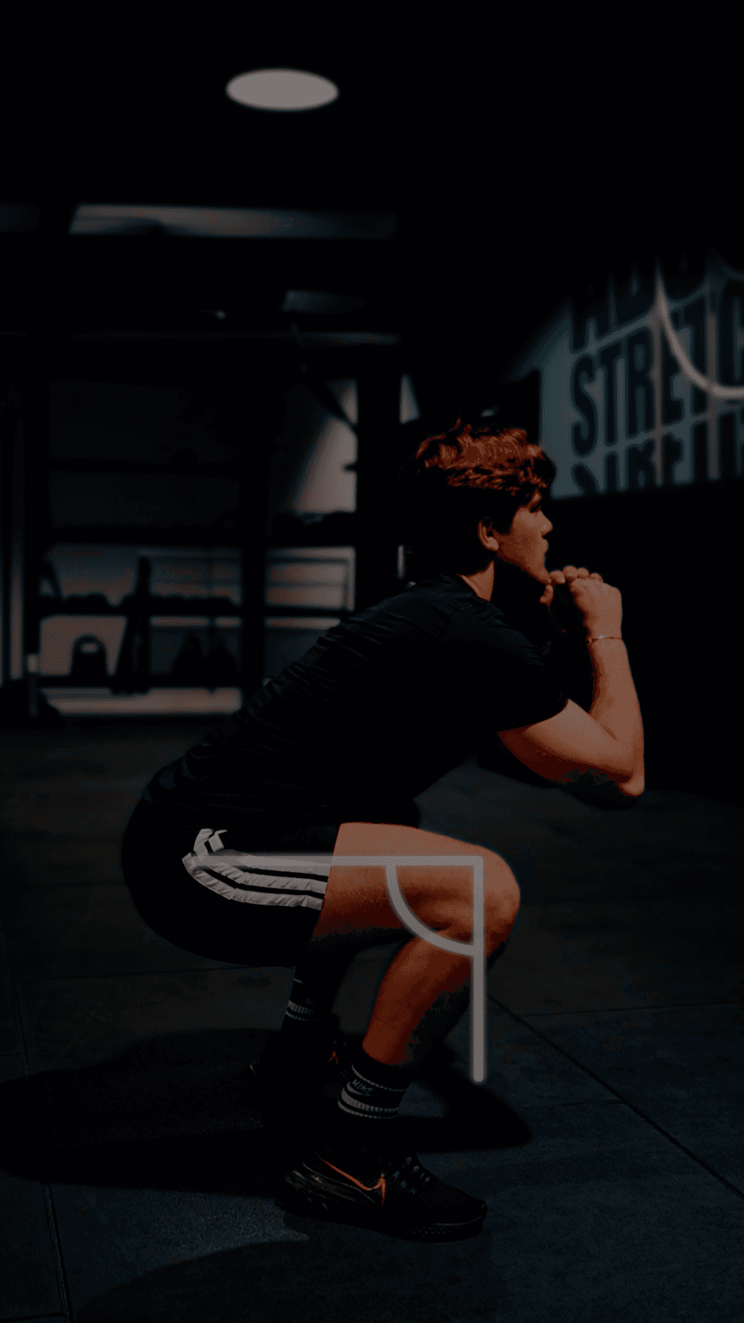 A person reviewing fitness activity on a mobile device inside a modern gym space, reflecting workout tracking, progress insights, and clear activity results.