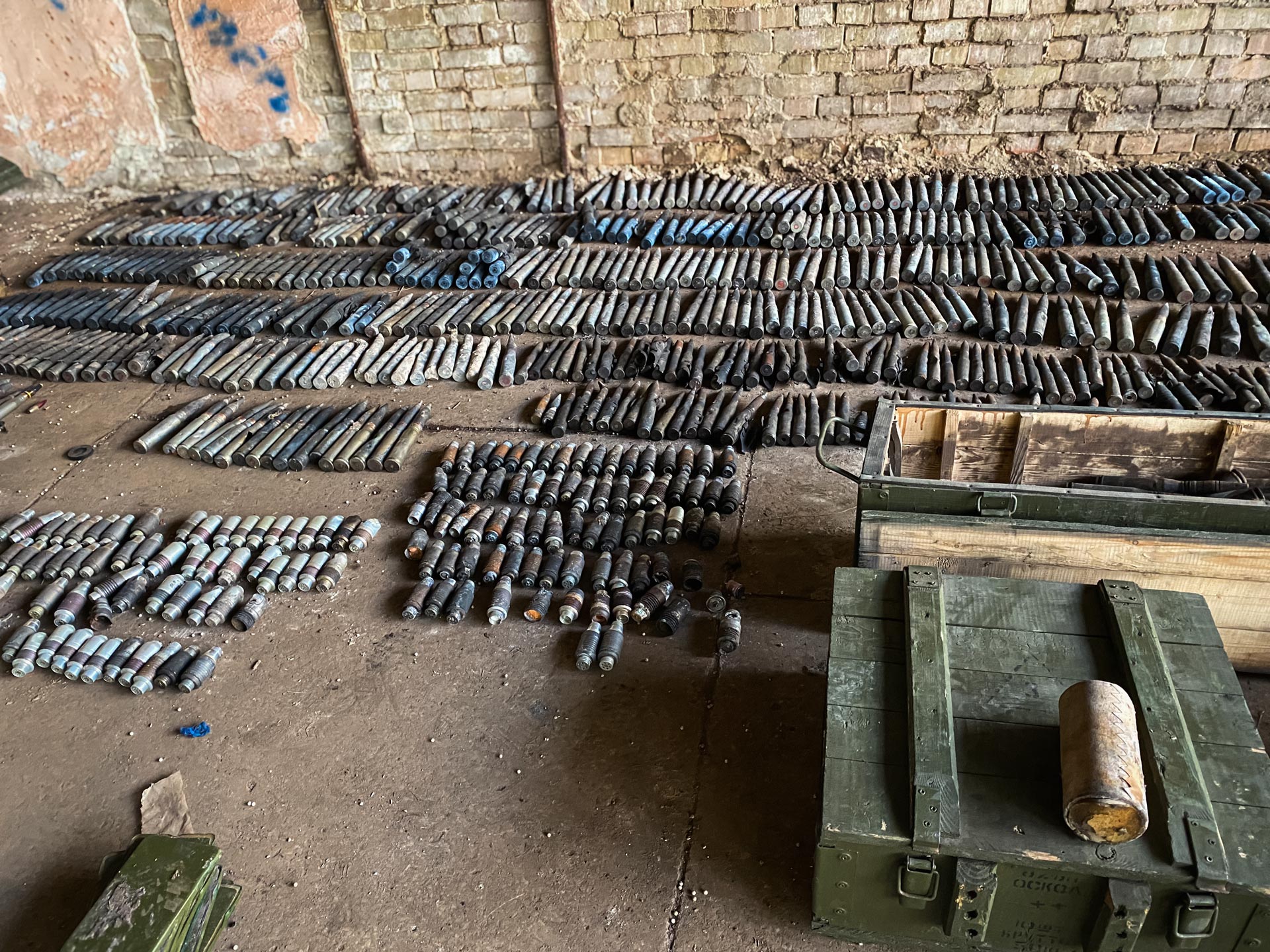 Large cache of recovered small arms ammunition and ordnance laid out for cataloguing during ammunition management operations in Ukraine.
