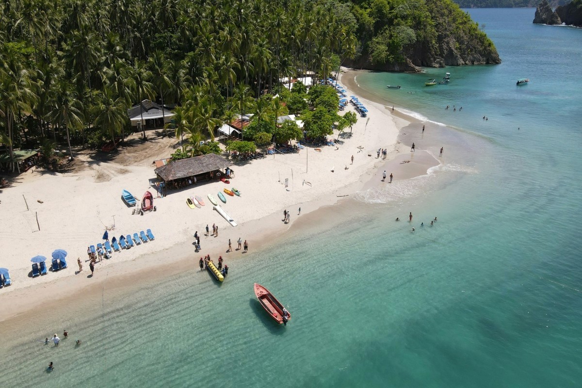 brown and white temple surrounded by green trees during daytime