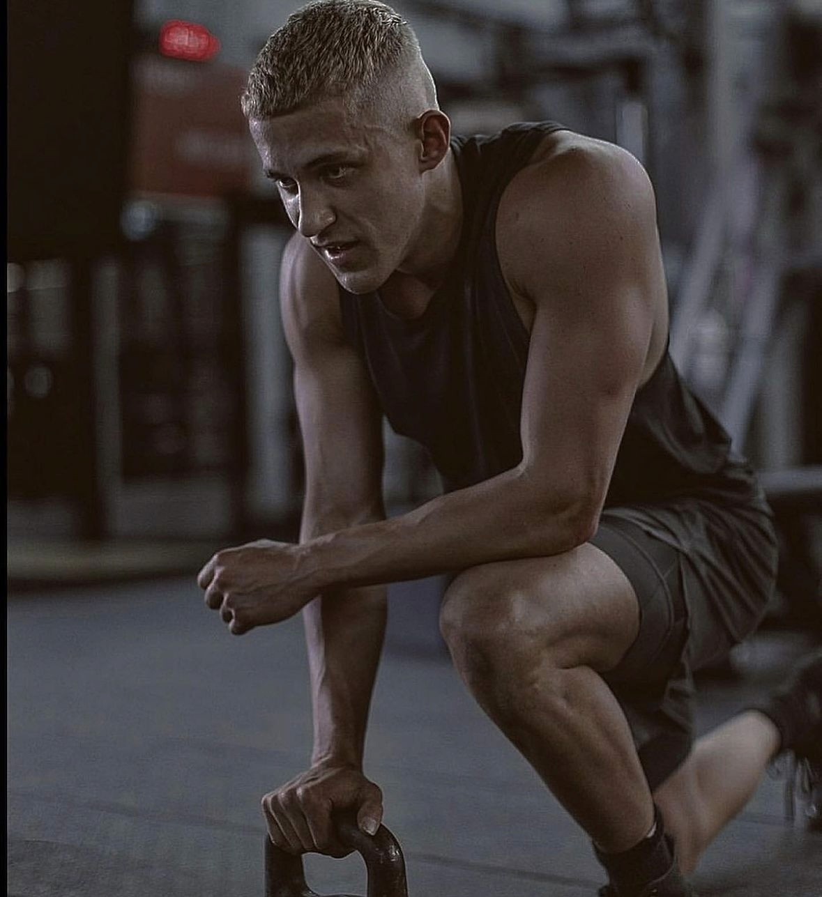 Black cosmetic product bottle against a dark background