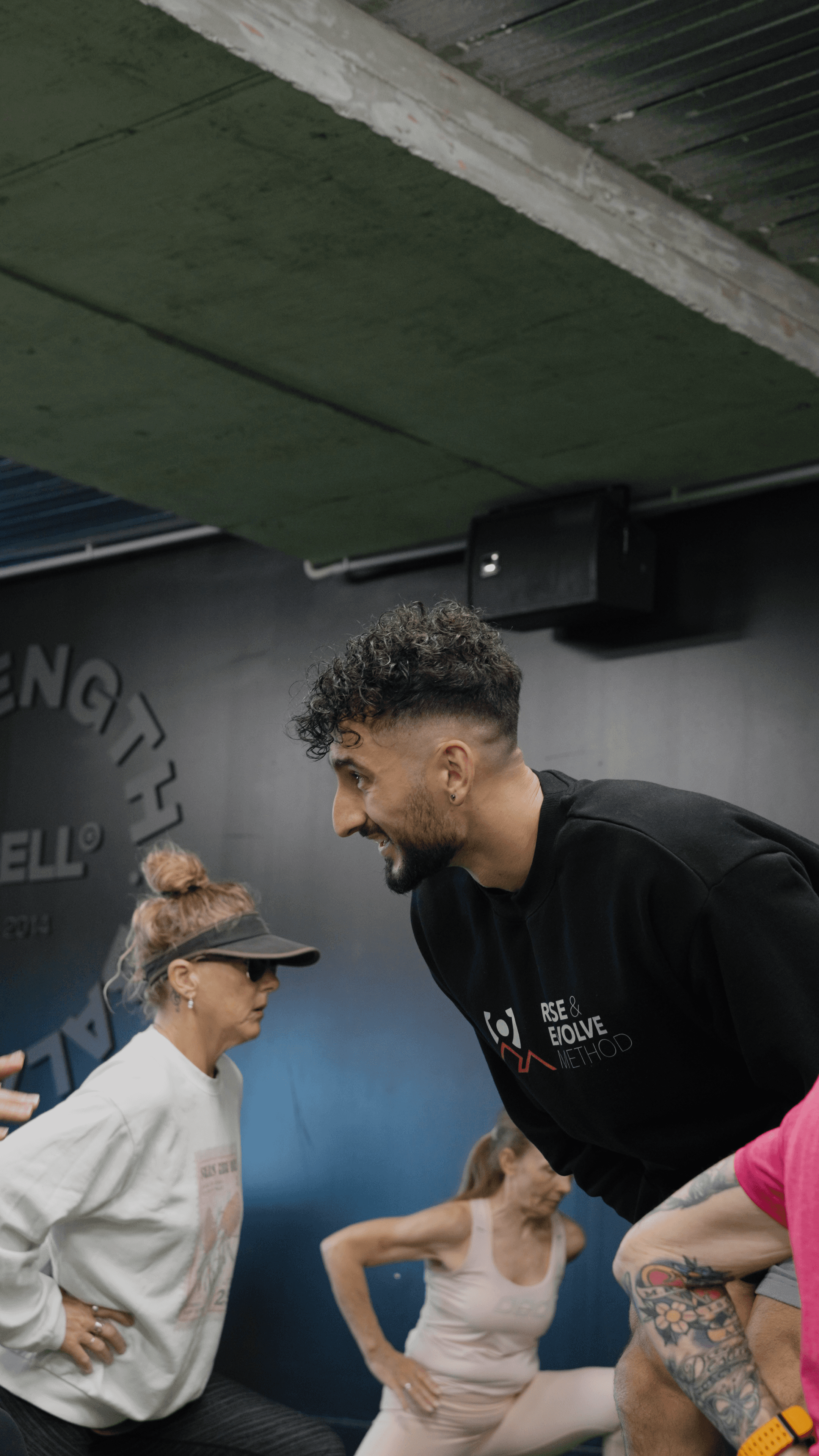 Coach working with an athlete during strength training