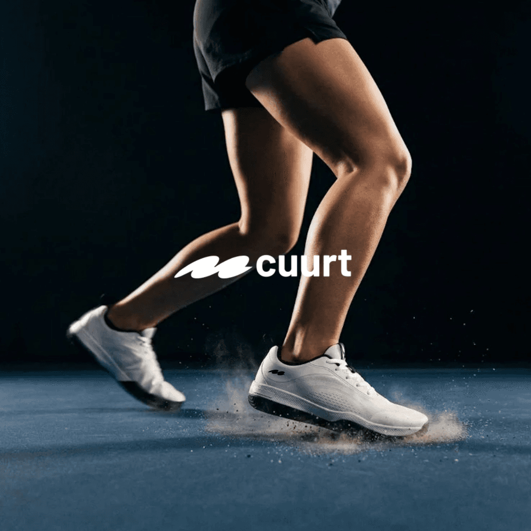 Runner wearing white sneakers in a dark Cuurata athletic footwear ad.