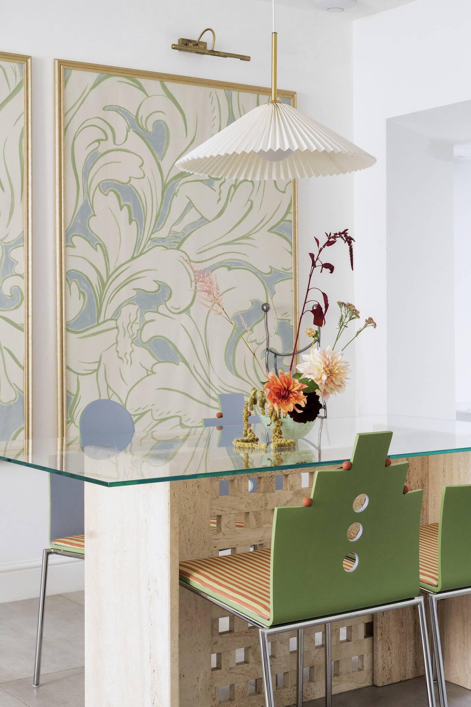 Brutalist travertine table, sculptural chairs, and oversized wallpaper in Brighton dining room by interior design studio Atelier Akuko