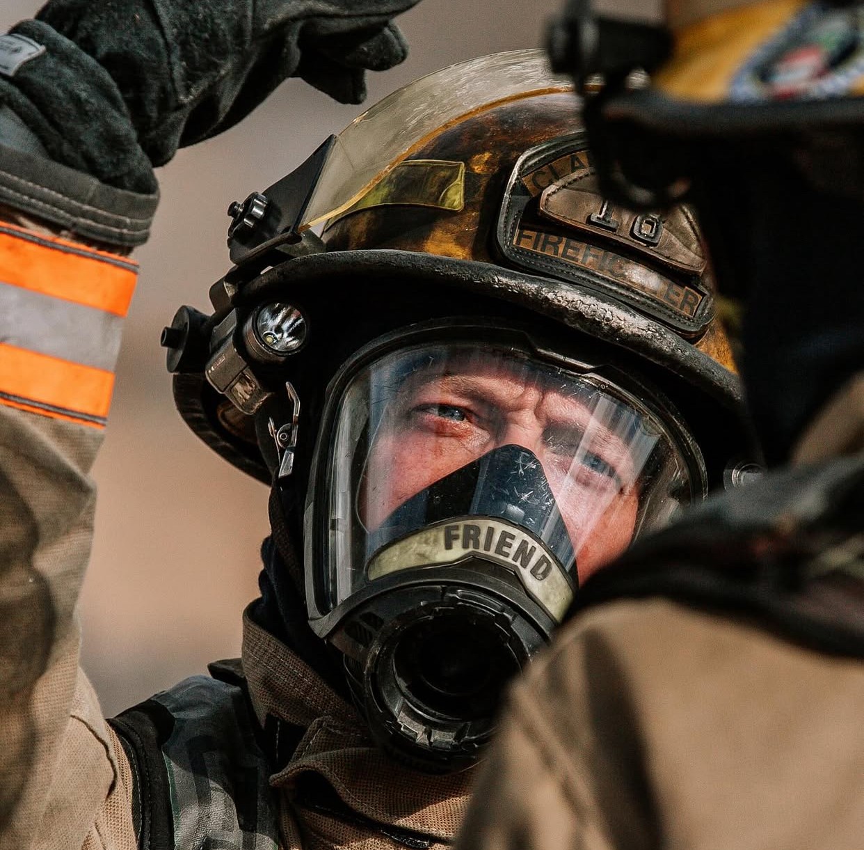 man in black helmet and black helmet standing near glass window