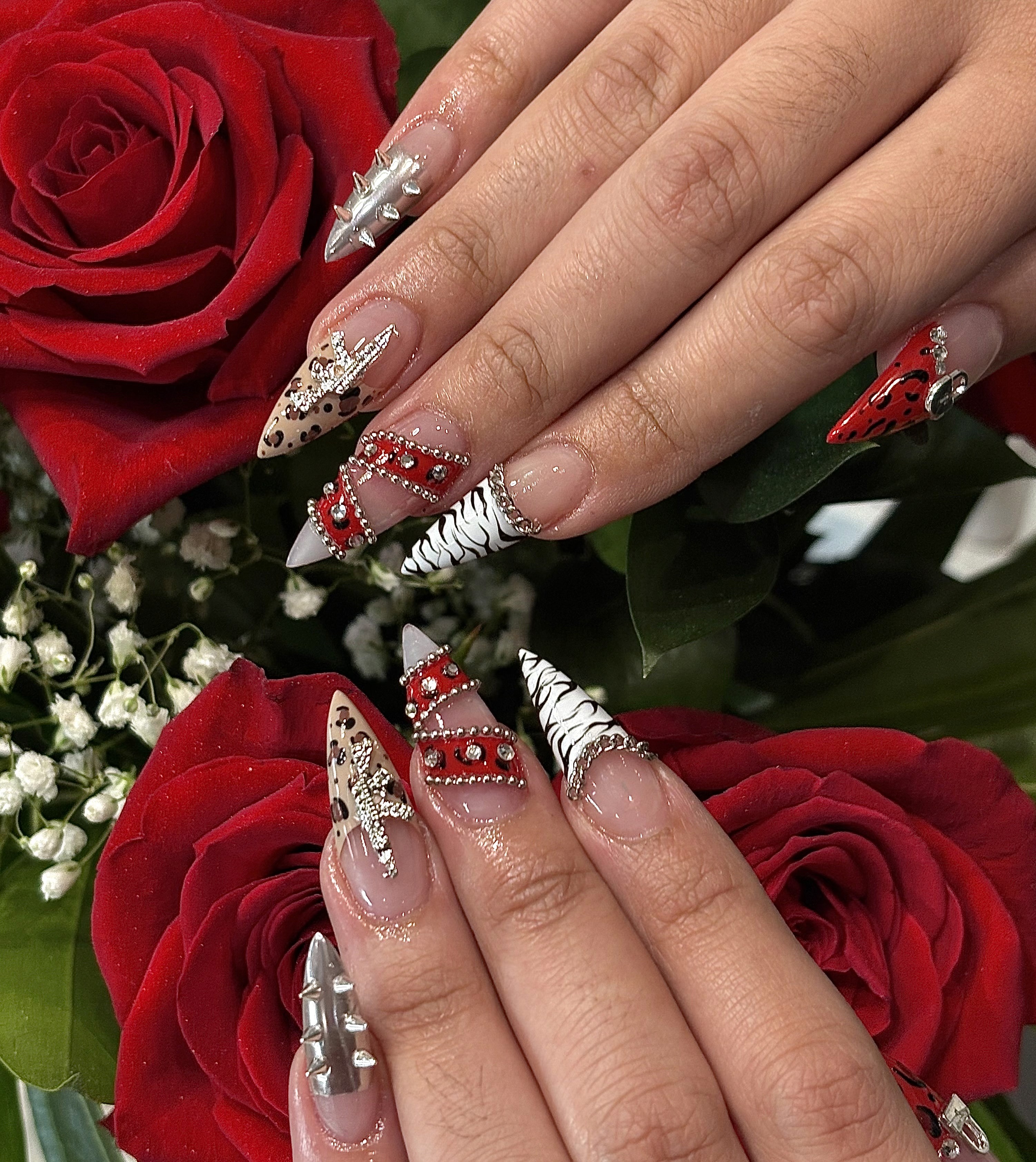 Acrylic nails with red and black nail art design at nail salon in Naperville Illinois