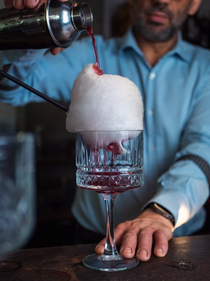 Close up of a cocktail being served at a bar