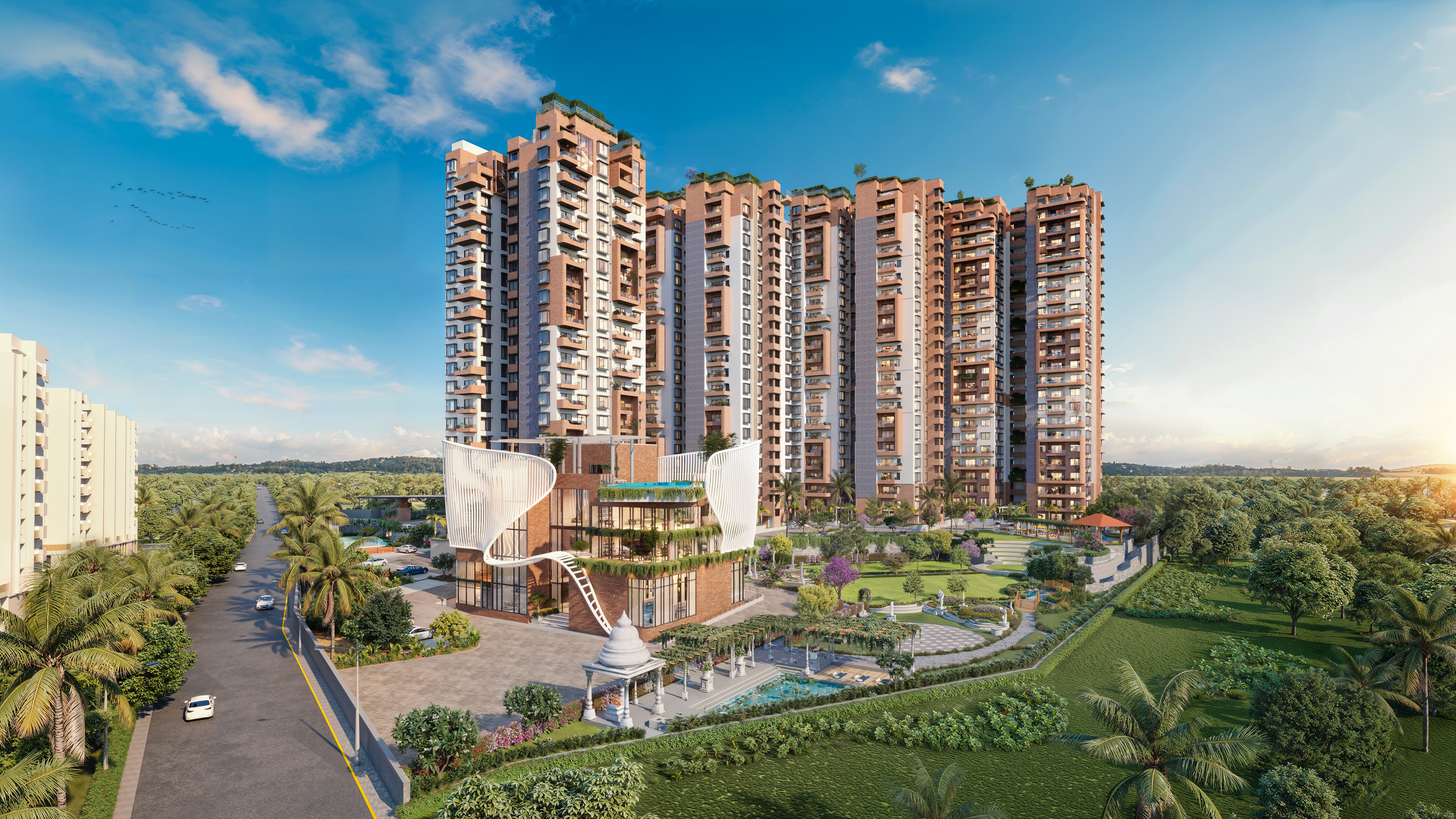 Aerial view of a winding road cutting through rocky terrain and sandy landscape.