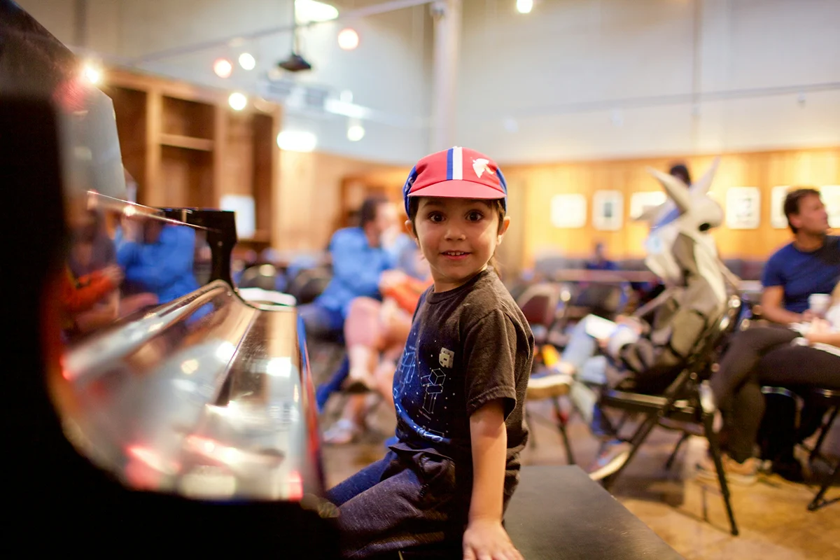 A boy seems very happy when played piano