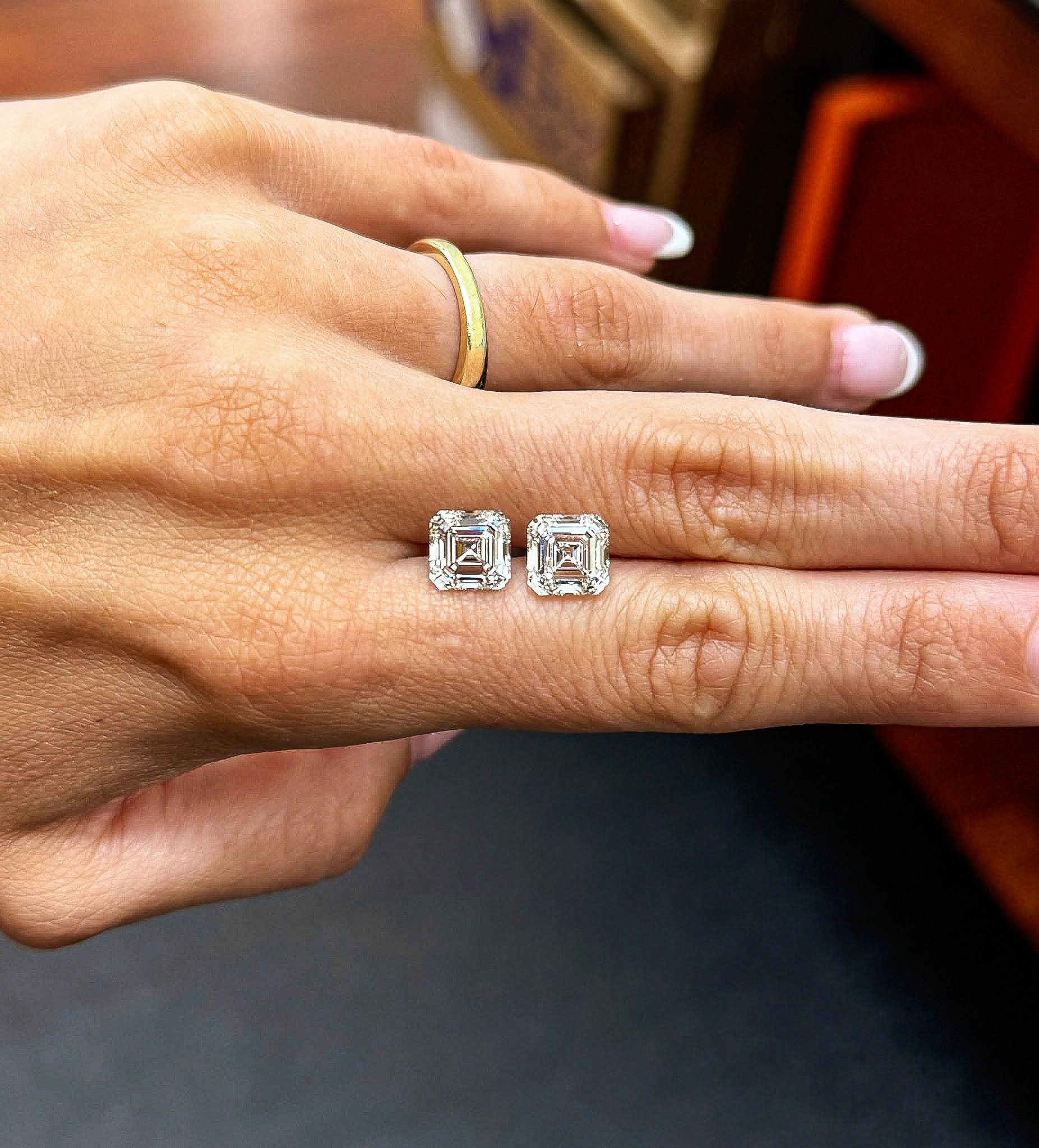 Pair of Asscher cut lab-grown diamonds showing step cut facets.