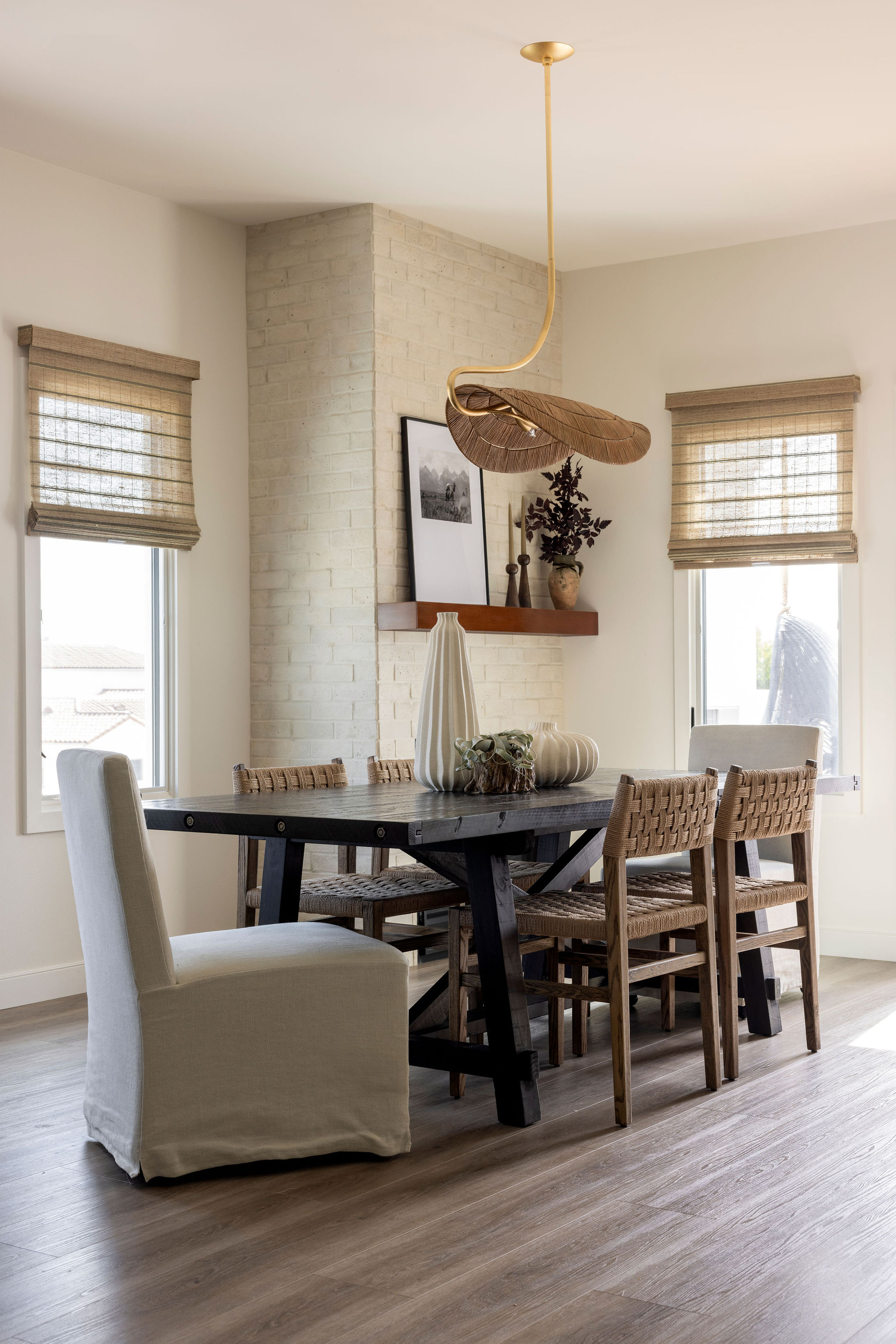 Spacious coastal living room featuring soft neutral tones, natural textures, and a statement art gallery that blends in with the mounted TV.