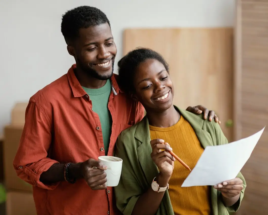 Smiley loving couple planning on their insurance plan